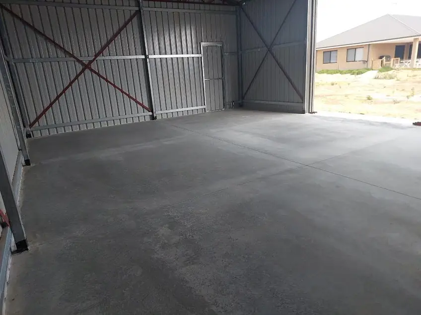 Finished plain concrete floor inside a steel shed