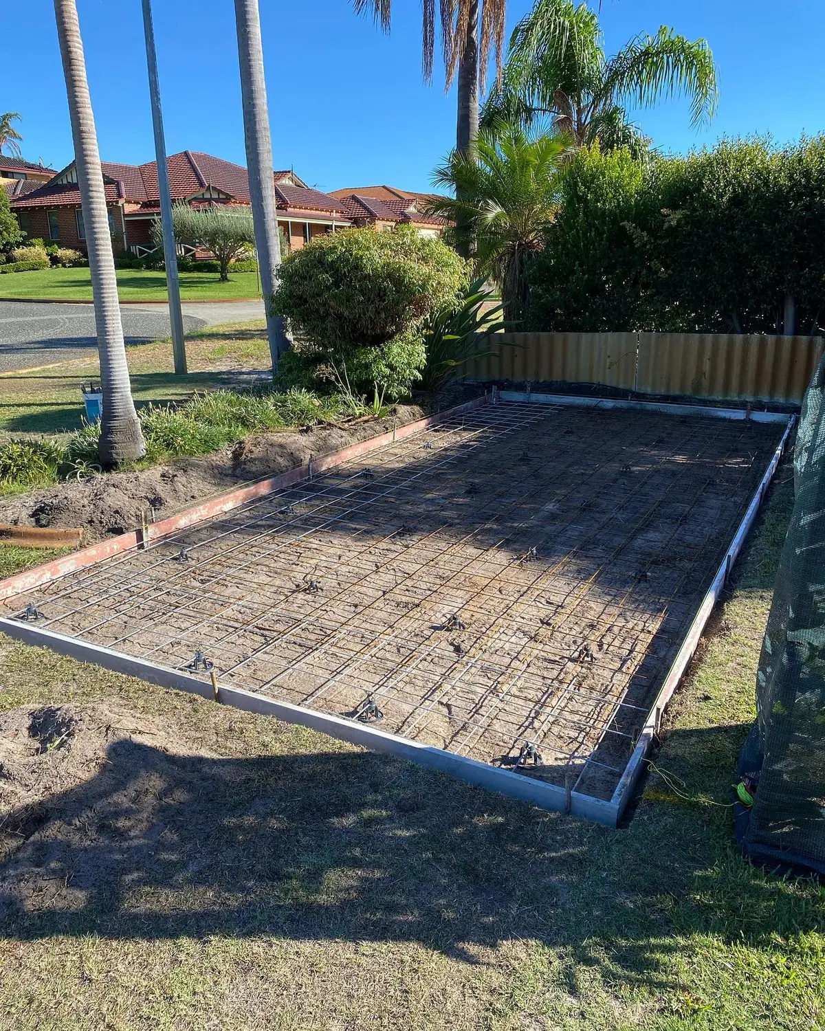 Mesh and formwork set for a slab in a front yard, ready for the truck